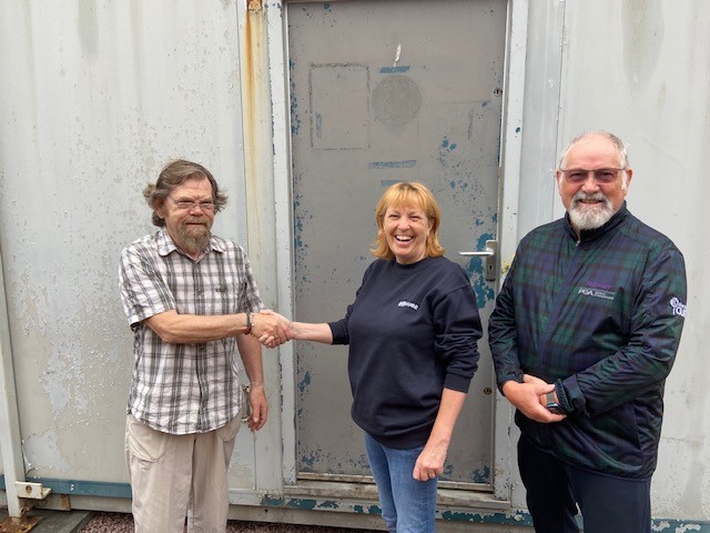 Handing over the keys to the donated portacabin