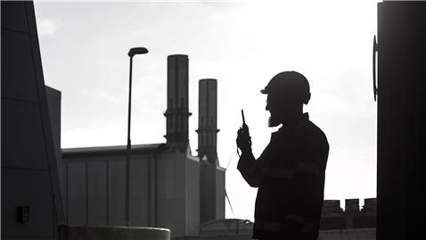 Employee using radio in silhouette