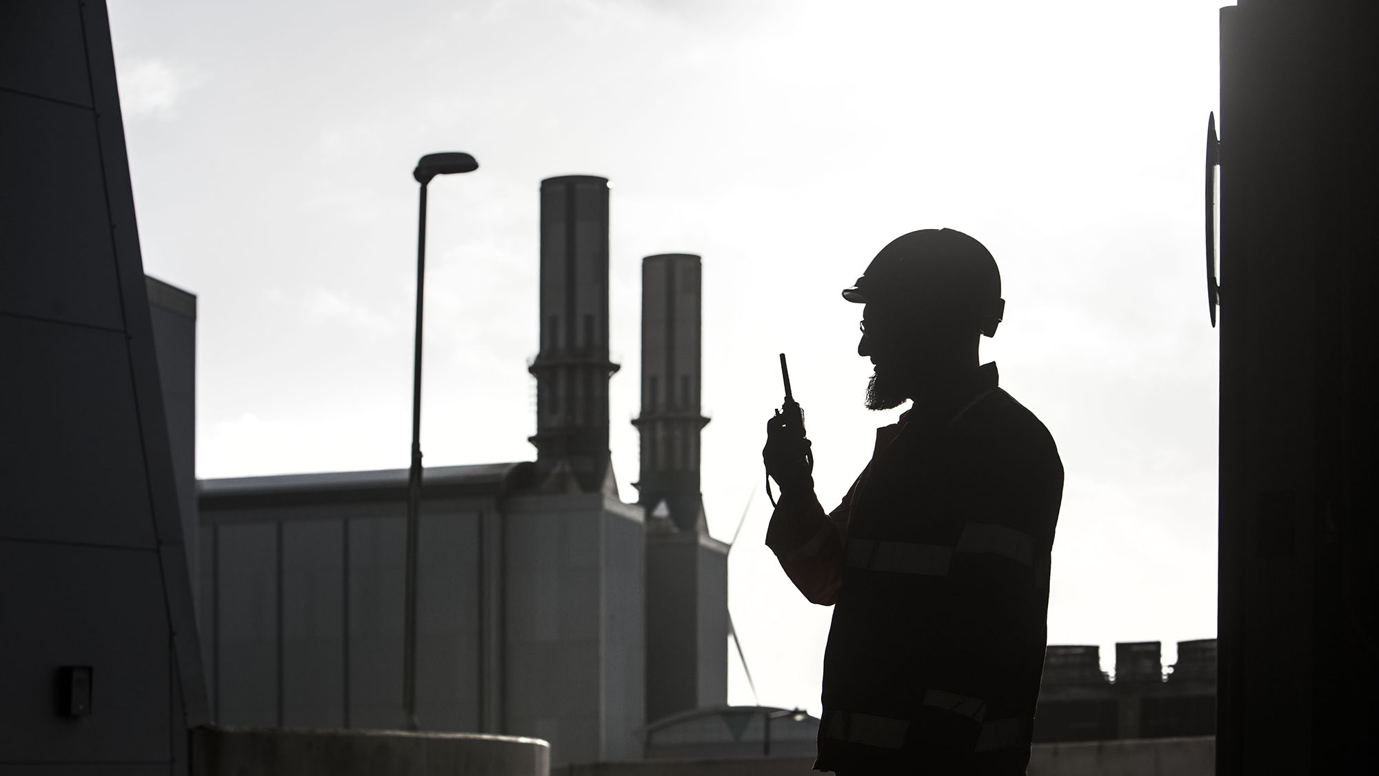 Employee using radio in silhouette