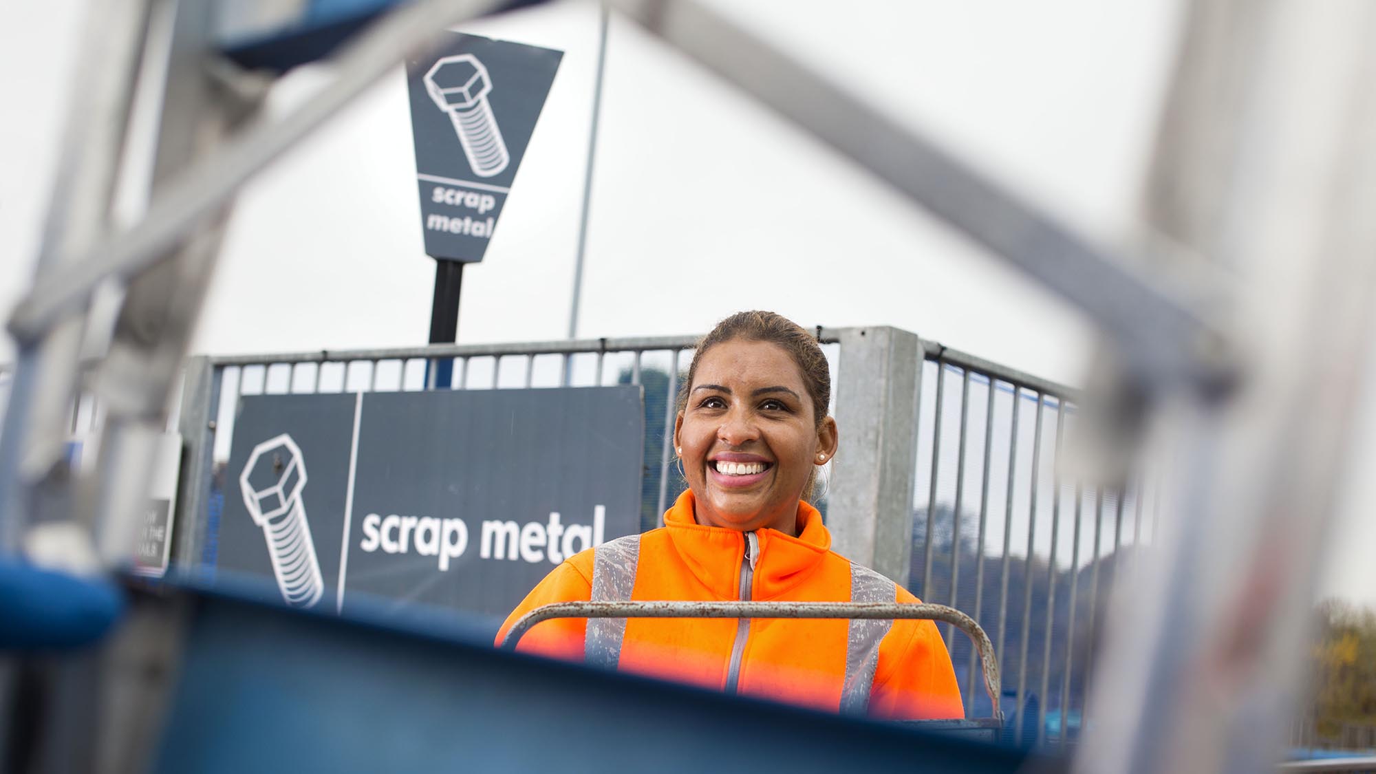 SUEZ employee by scrap metal bay at household waste recycling centre