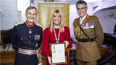Holding the Gold Award certificate
