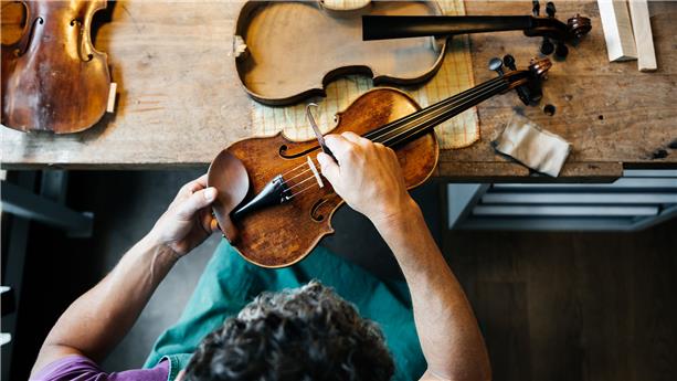 Person repairing a violin