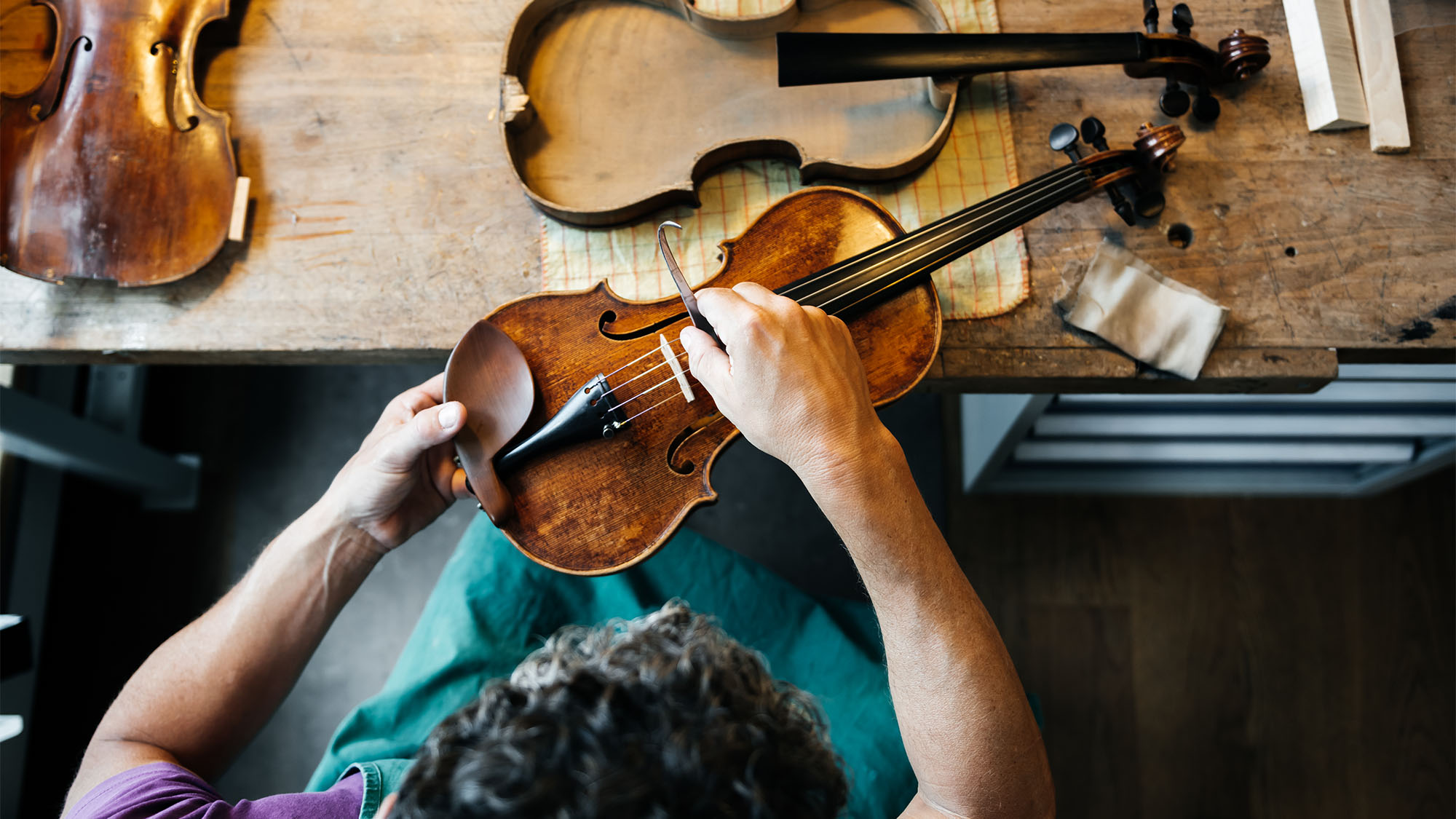 Person repairing a violin