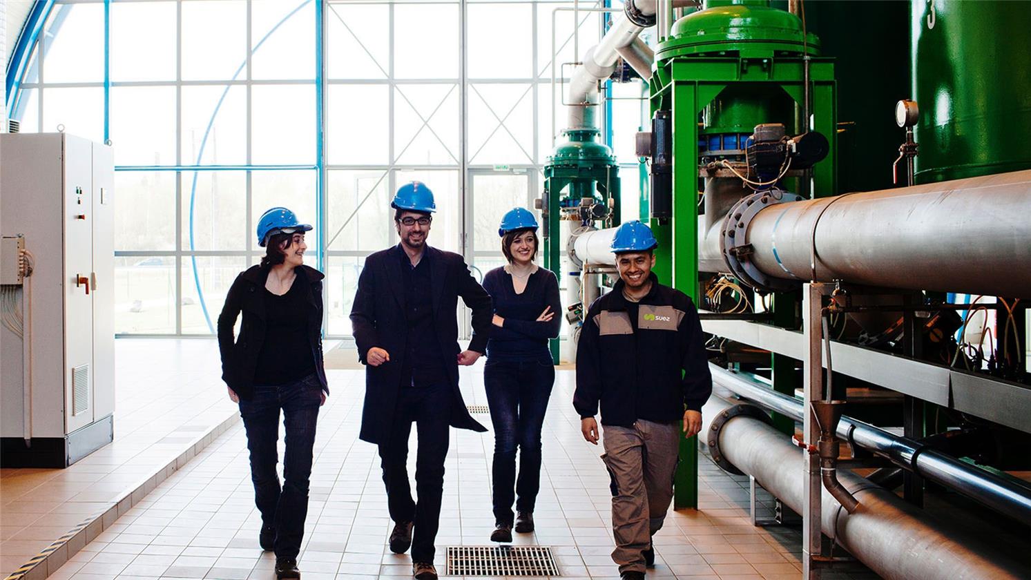 Employees walking round facility